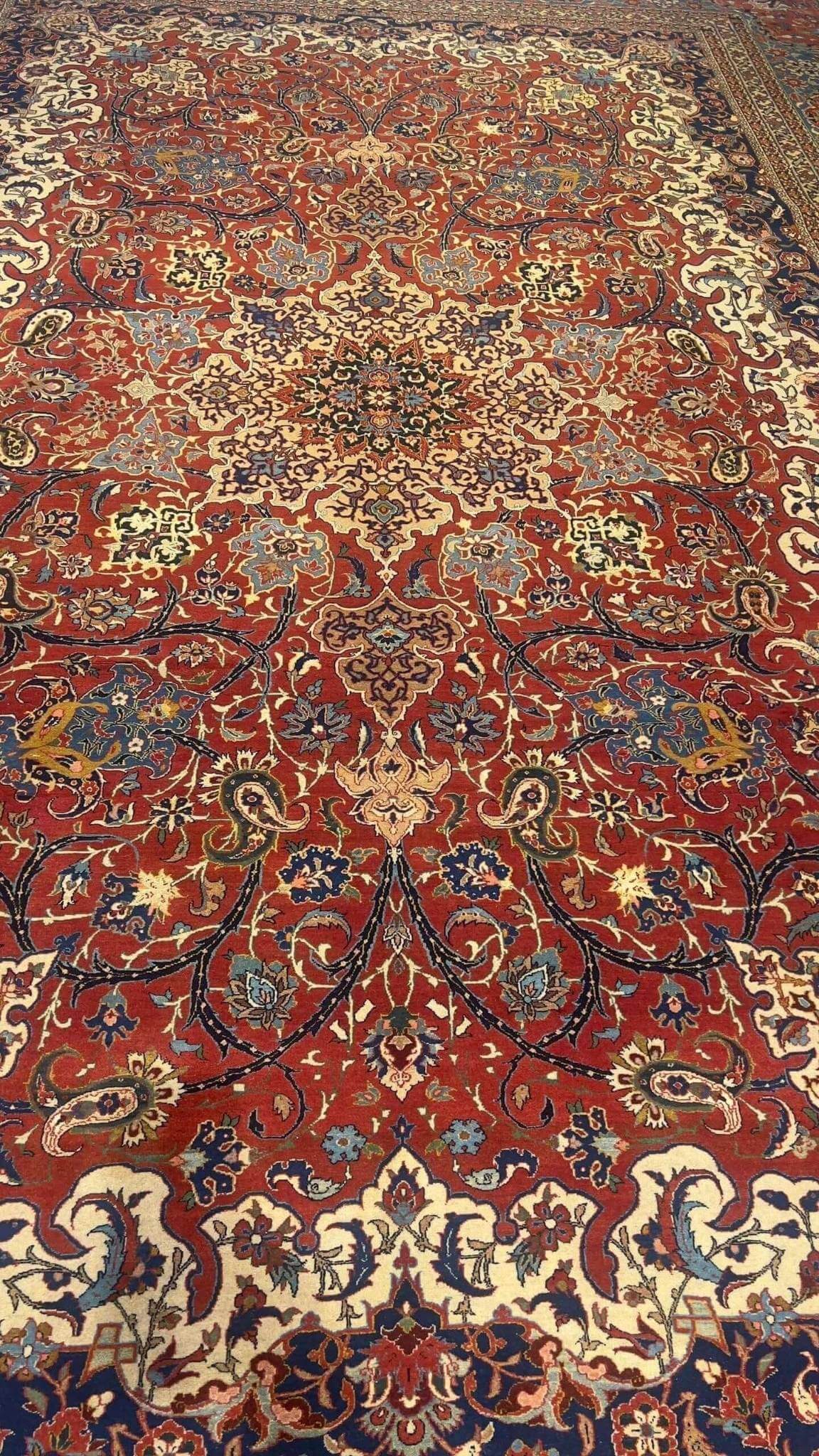 "100-year-old Isfahan rug with natural dyes, showcasing classic Persian craftsmanship and medallion design"